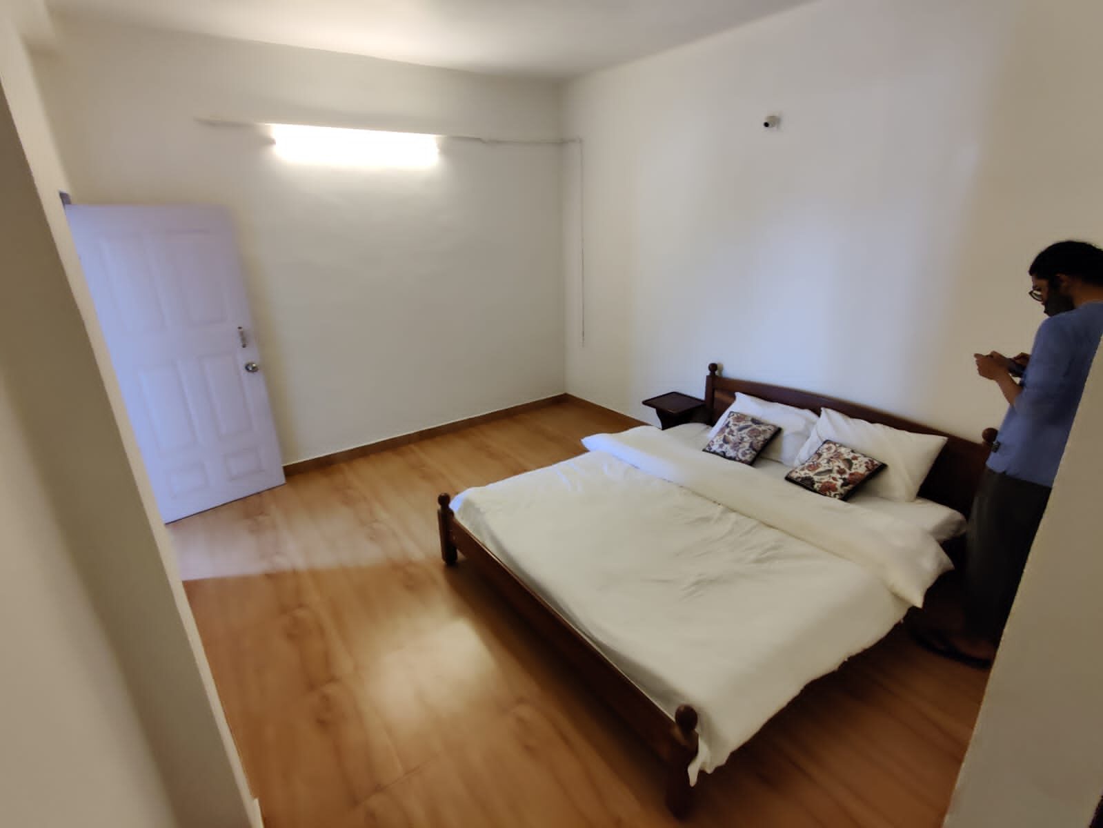Guest bedroom with a double bed and wooden wardrobe